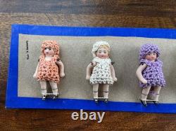 6 clothed antique porcelain dolls on sample card Hertwig & Co
