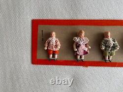 6 clothed antique porcelain dolls on sample card Hertwig & Co