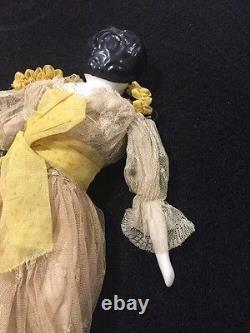 A Molded Bun China Head Doll