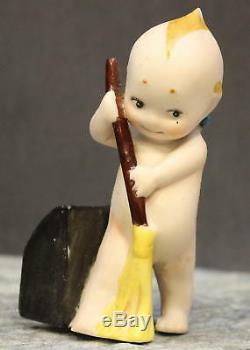 Antique Porcelain Kewpie Sweeping With A Broom