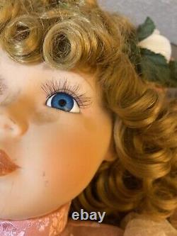 Charming Vintage Porcelain Doll with Blonde Curly Hair and Dress