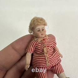 VINTAGE or ANTIQUE MINIATURE PORCELAIN BOY DOLL IN STRIPED CLOTHES DOLLHOUSE