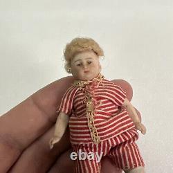 VINTAGE or ANTIQUE MINIATURE PORCELAIN BOY DOLL IN STRIPED CLOTHES DOLLHOUSE