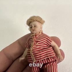 VINTAGE or ANTIQUE MINIATURE PORCELAIN BOY DOLL IN STRIPED CLOTHES DOLLHOUSE