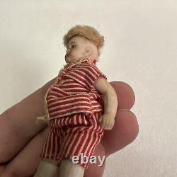 VINTAGE or ANTIQUE MINIATURE PORCELAIN BOY DOLL IN STRIPED CLOTHES DOLLHOUSE