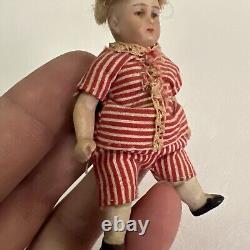 VINTAGE or ANTIQUE MINIATURE PORCELAIN BOY DOLL IN STRIPED CLOTHES DOLLHOUSE