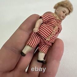 VINTAGE or ANTIQUE MINIATURE PORCELAIN BOY DOLL IN STRIPED CLOTHES DOLLHOUSE