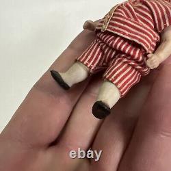 VINTAGE or ANTIQUE MINIATURE PORCELAIN BOY DOLL IN STRIPED CLOTHES DOLLHOUSE