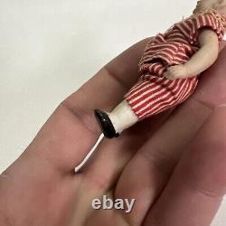 VINTAGE or ANTIQUE MINIATURE PORCELAIN BOY DOLL IN STRIPED CLOTHES DOLLHOUSE