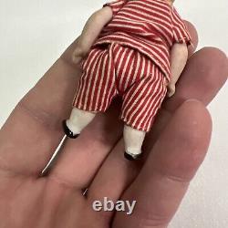 VINTAGE or ANTIQUE MINIATURE PORCELAIN BOY DOLL IN STRIPED CLOTHES DOLLHOUSE