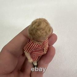 VINTAGE or ANTIQUE MINIATURE PORCELAIN BOY DOLL IN STRIPED CLOTHES DOLLHOUSE