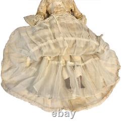 Vintage 19 porcelain doll in ornate dress with petticoats