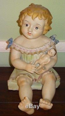 Vintage Germany 11 1/2 Porcelain Piano Baby Girl Holding Doll