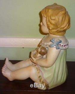 Vintage Germany 11 1/2 Porcelain Piano Baby Girl Holding Doll