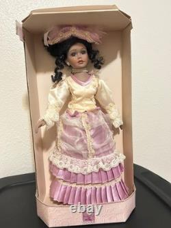 Vintage J Misa Collection Victorian-style porcelain doll with a pink and cream