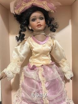Vintage J Misa Collection Victorian-style porcelain doll with a pink and cream