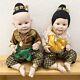 Vintage Pair Of Asian Thai Porcelain Toddler Doll Wearing Traditional Clothes