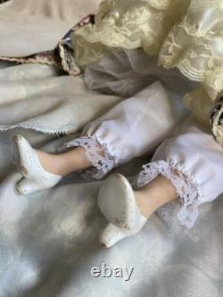Vintage Victorian Porcelain Doll with curly hair