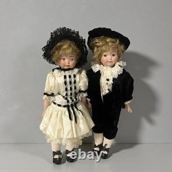 Paire de poupées en porcelaine Vintage 15 avec têtes à douille, corps en cuir et yeux Googly
