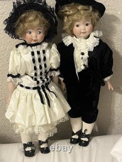 Paire de poupées en porcelaine Vintage 15 avec têtes à douille, corps en cuir et yeux Googly